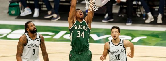 Giannis returns with  49, Bucks escape Nets