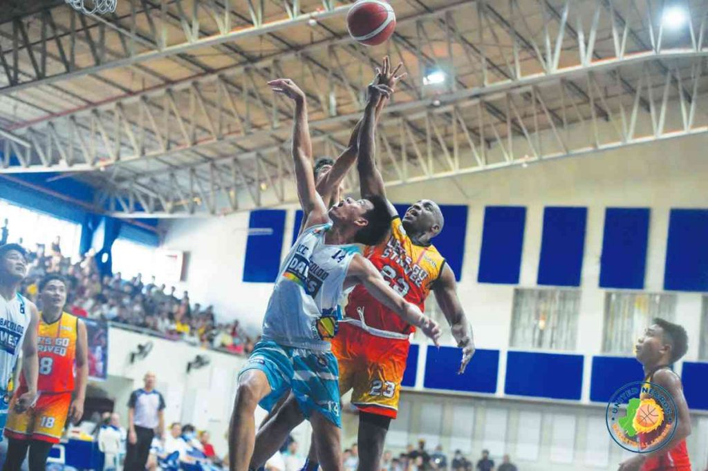 Arnaud Noah of Let’s Go Strived–CSA-B battles the players of Team Davies Paint–LCC-B for the rebound. (Photo courtesy of Stephen Tan)