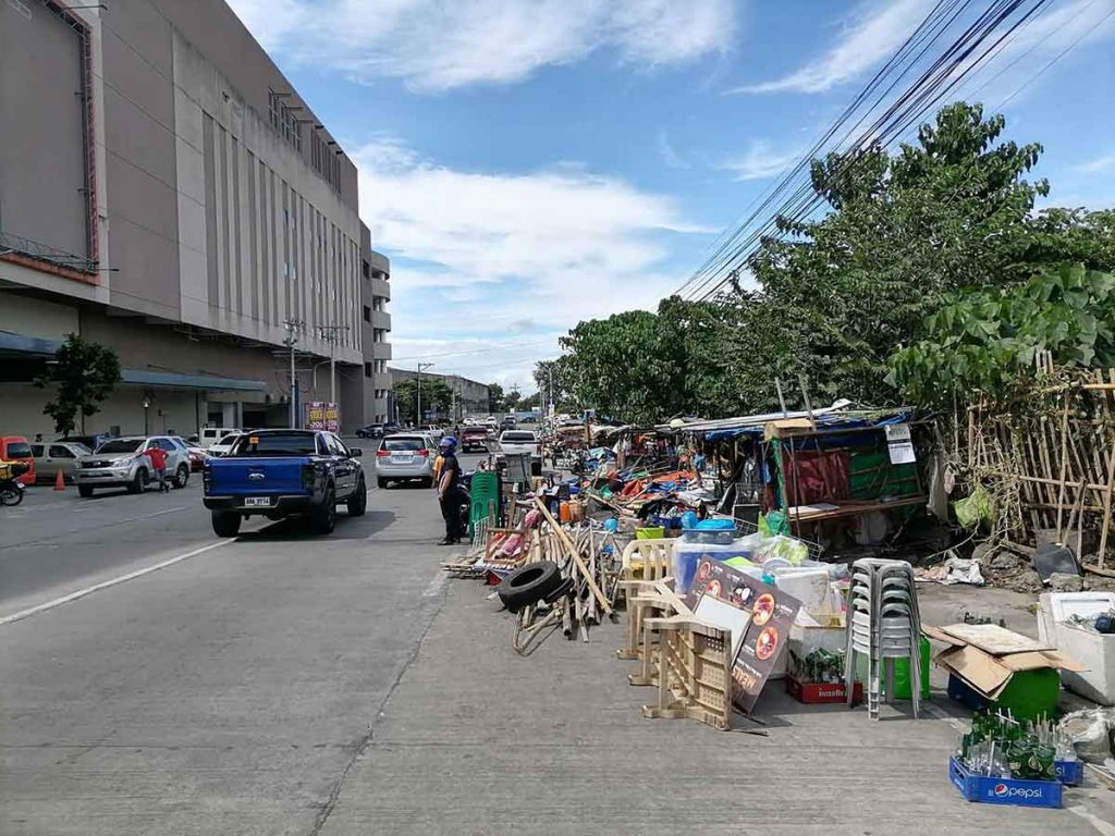 Photo shows illegal structures were removed along Bacolod City's North Capitol Road yesterday morning. The roadside once accommodated several eateries, coffee shops and sari-sari stores. (Dominique Gabriel G. Bañaga photo)