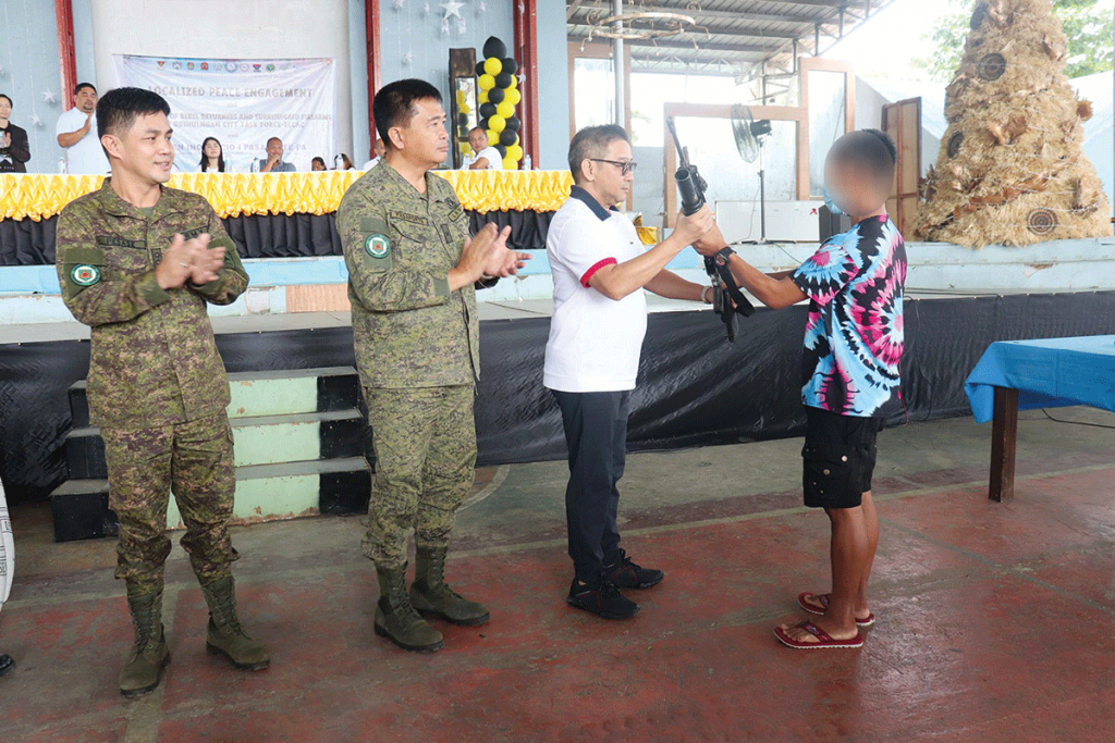 Photo shows a former New People's Army member surrenders his firearm in a ceremony held in Negros Oriental’s Guihulngan City last Monday, December 26. According to them, they decided to leave the movement due to exhaustion and hunger brought by the incessant pursuit by government forces. (62nd Infantry Battalion photo) 