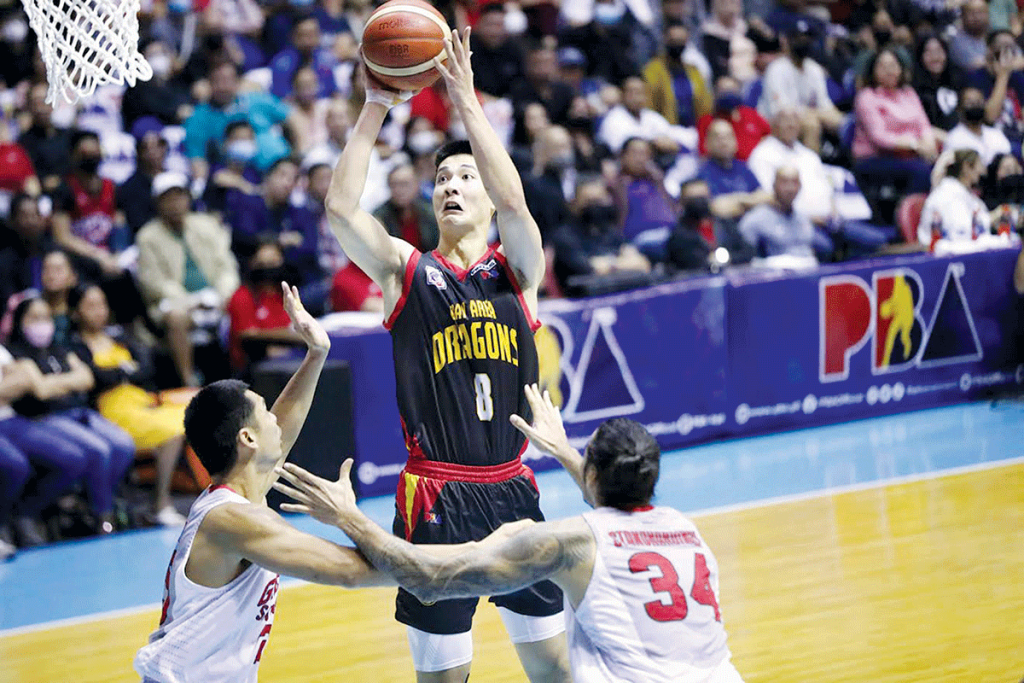 Bay Area Dragons’ Zhu Songwei attempts a basket against the defense of Barangay Ginebra San Miguel Kings’ Japeth Aguilar and Christian Standhardinger. (PBA photo)