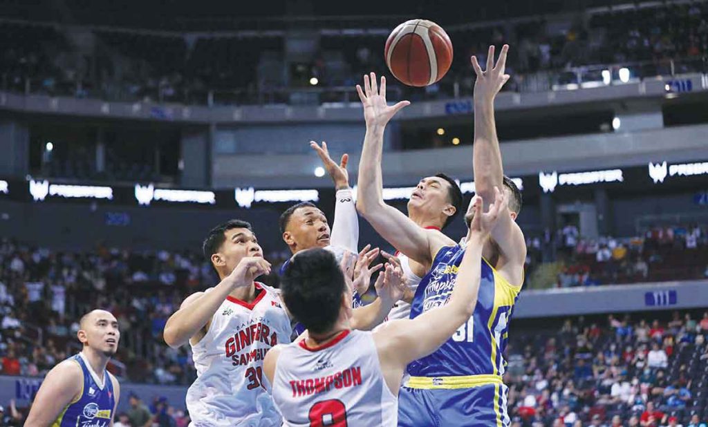 Barangay Ginebra San Miguel Kings' Japeth Aguilar and Magnolia Chicken Timplados Hotshots' Nicholas Rakocevic battle for a rebound. (PBA photo)