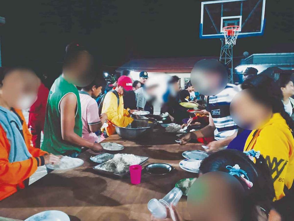 The affected residents in at least three sub-villages in Negros Occidental’s Kabankalan City temporarily spent the night at a barangay covered court after reportedly hearing gunfire on Friday night, December 2, 2022. (Southern News TV photo)