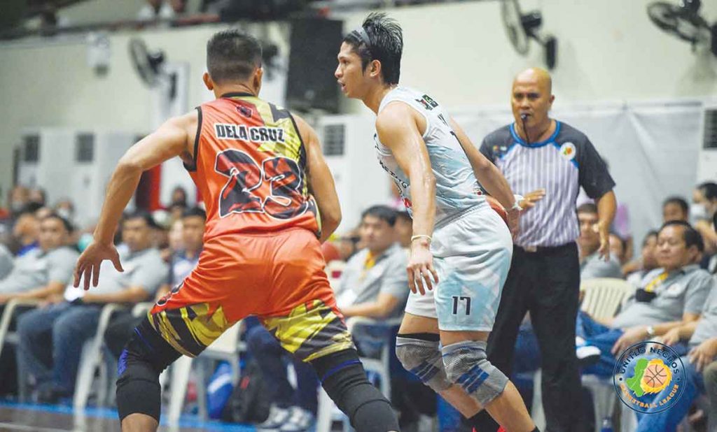 Acster Marketing’s Alwyn Alday dribbles the ball against a RA-AK Transport defender. (Photo courtesy of Stephen Tan)