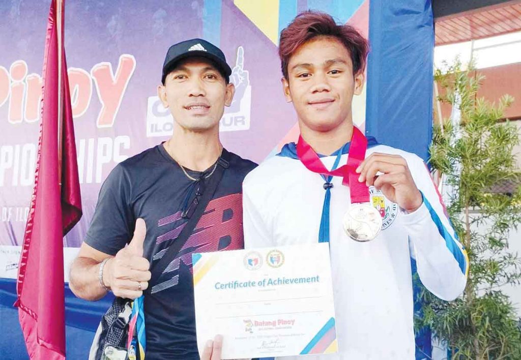 Bacolodnon hurdler Mico Villaran displays his gold medal with his head coach Miguel Arca. (Photo courtesy of Miguel Arca)