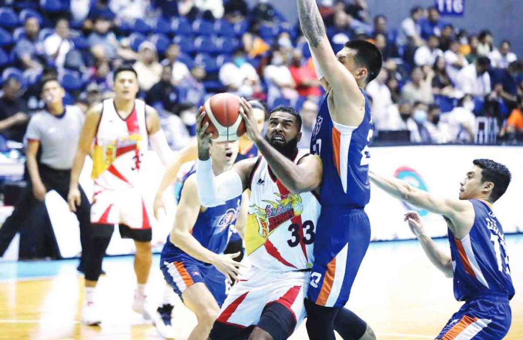 San Miguel Beermen’s Moala Tautuaa tries to score against the defense of Meralco Bolts’ Raymond Almazan. (PBA photo)