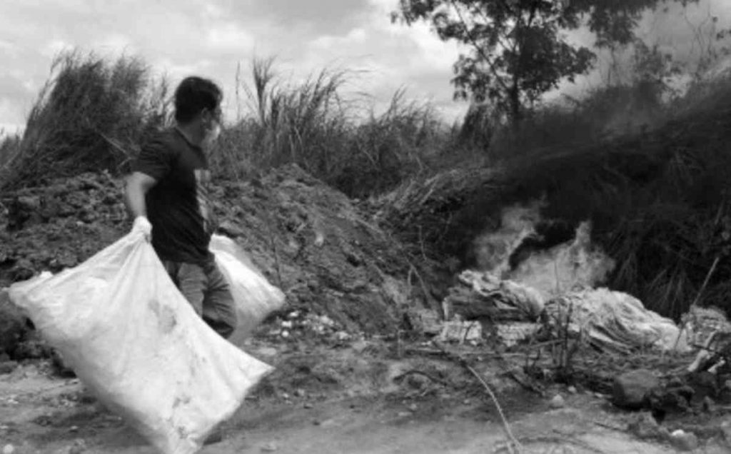 A veterinary quarantine personnel burns the undocumented table eggs transported from Cebu province’s Bantayan Island after the shipment was intercepted at the BREDCO Port in Bacolod City on February 5, 2022. The 240,000 pieces of eggs were shipped without a permit and other pertinent documents. (BAI-Veterinary Quarantine Station 6 photo)