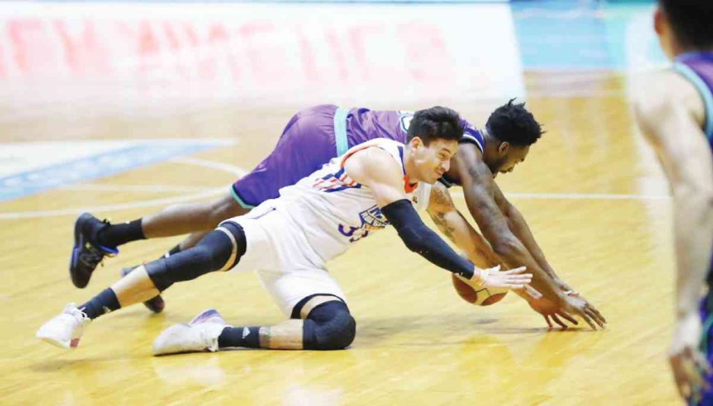 NLEX Road Warriors’ Anthony Semerad and Converge FiberXers’ Jamaal Franklin go down on the floor as they battle for a looseball. (PBA photo)