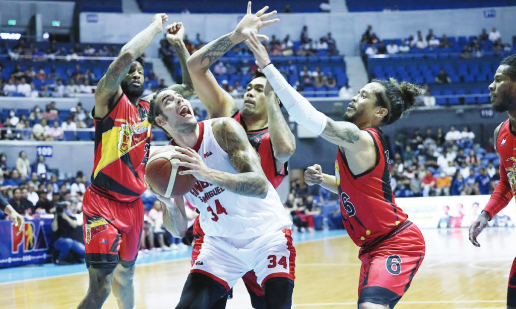 Barangay Ginebra San Miguel Kings’ Christian Standhardinger handles the ball while being clobbered by San Miguel Beermen’s Cameron Clark, Vic Manuel and Chris Ross. (PBA photo)