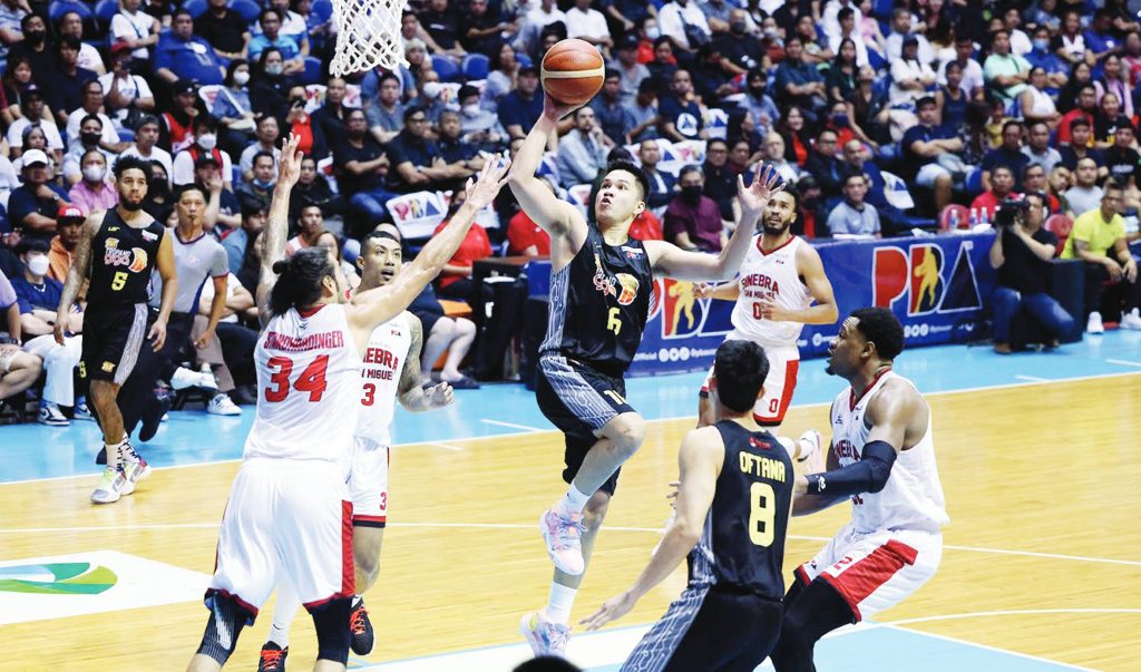 TNT Tropang Giga’s Roger Pogoy attempts a floater against the defense of Barangay Ginebra San Miguel Kings’ Christian Standhardinger. (PBA photo)