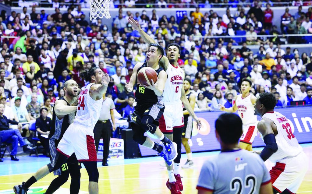 Bacolodnon Kib Montalbo of TNT Tropang Giga evades the defense of Barangay Ginebra San Miguel Kings’ Christian Standhardinger and Jeremiah Gray for a tough basket. (PBA photo)