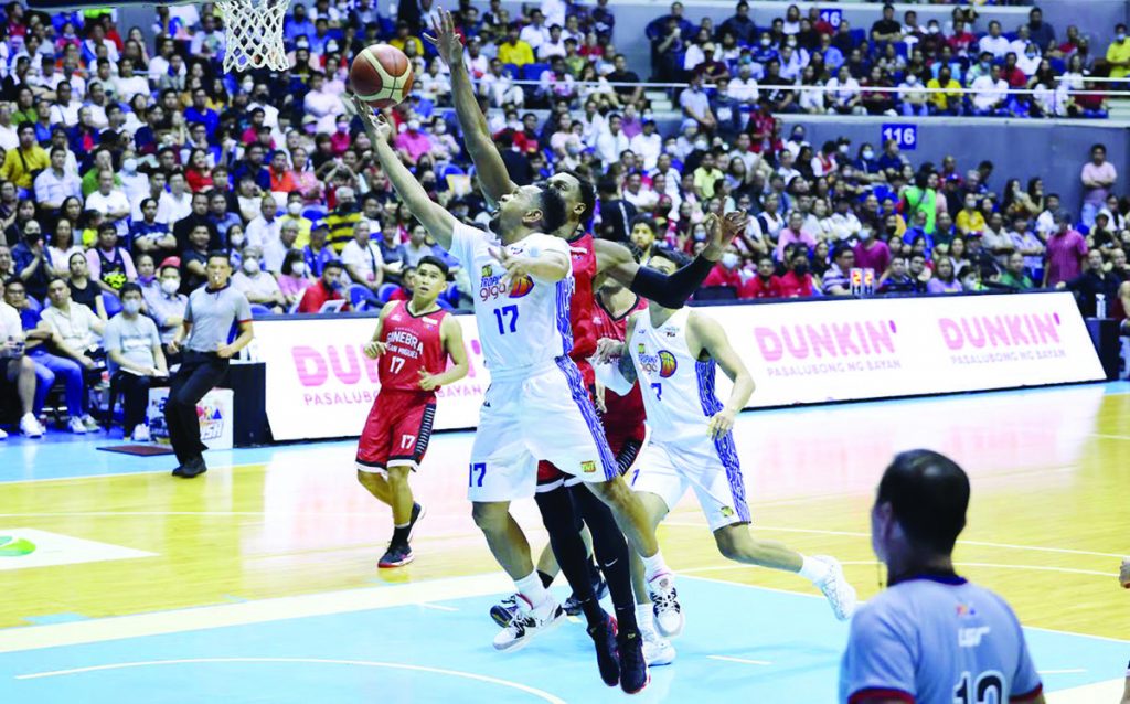 TNT Tropang Giga guard Jayson Castro stretches for a layup against the defense of Barangay Ginebra San Miguel Kings. (PBA photo)