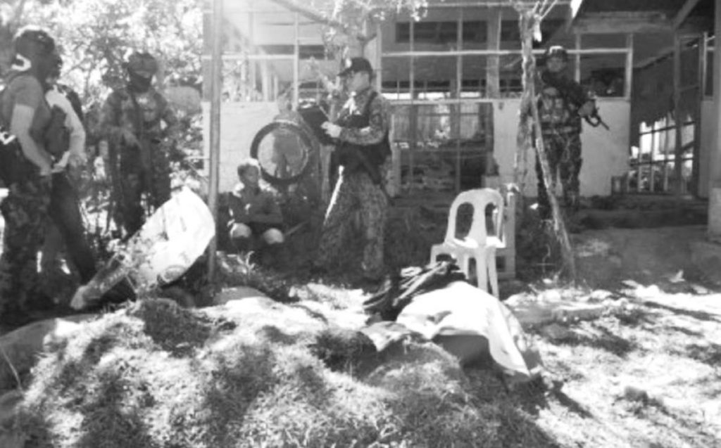 Police investigators process the crime scene where two civilians were shot dead on Tuesday night, April 18, 2023, in a remote village in Negros Oriental’s Guihulngan City. Suspected New People's Army members are believed to have perpetrated the crime. (Negros Oriental Police Provincial Office photo)