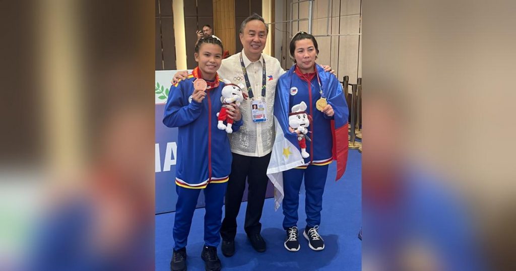 Christina Vergara and her daughter Cathlyn Gee pose for a photo with Philippine Olympic Committee President Abraham Tolentino after winning gold and bronze in freestyle wrestling in the 32nd Southeast Asian Games in Phnom Penh, Cambodia. (Photo by Philippine Media Pool)