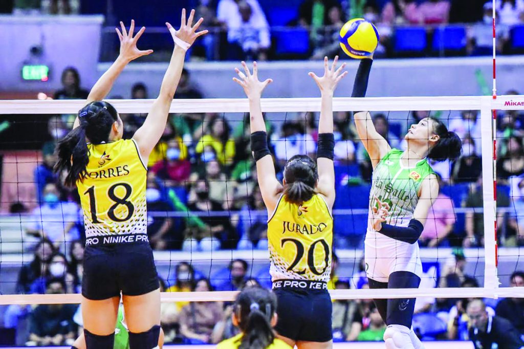 Bacolodnon Angel Canino of De La Salle University Lady Spikers goes for an attack against University of Santo Tomas Golden Tigresses’ Regina Jurado. (UAAP photo)