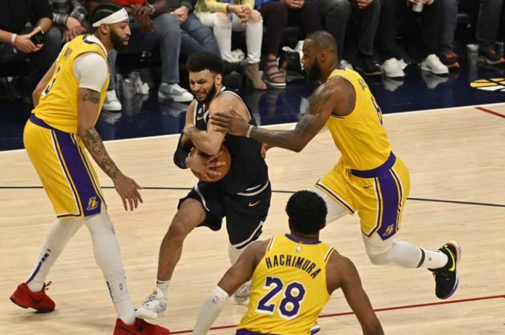 Denver Nuggets guard Jamal Murray of Canada (center) protects the ball from Los Angeles Lakers forwards LeBron James and Anthony Davis in Game 2 of the NBA Western Conference finals series between the Los Angeles Lakers and the Denver Nuggets at Ball Arena in Denver, Colorado. (Bob Pearson / EPA-EFE photo)