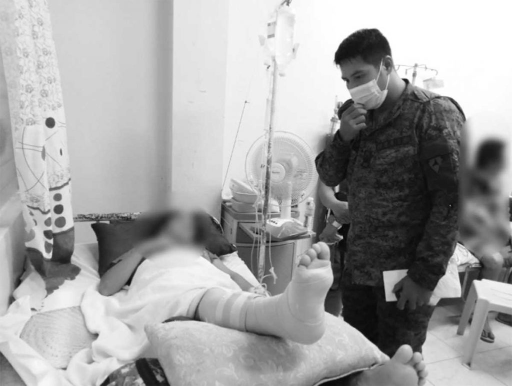 A trooper visits a civilian at a district hospital in Negros Occidental’s Himamaylan City who was wounded in an encounter in the city’s Barangay Buenavista on Wednesday, May 3, 2023. (303rd Infantry Brigade photo)