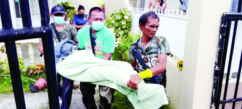 Authorities retrieved the body of call center agent Liezel Demerin-St. Jean, who was stabbed to death by her Canadian husband in their home at Villa Mikaela Subdivision in Bacolod City's Barangay Singcang-Airport yesterday morning, May 12, 2023. The suspect also stabbed himself and rushed to a hospital but was dead on arrival. (Dominique Gabriel G. Bañaga photo)