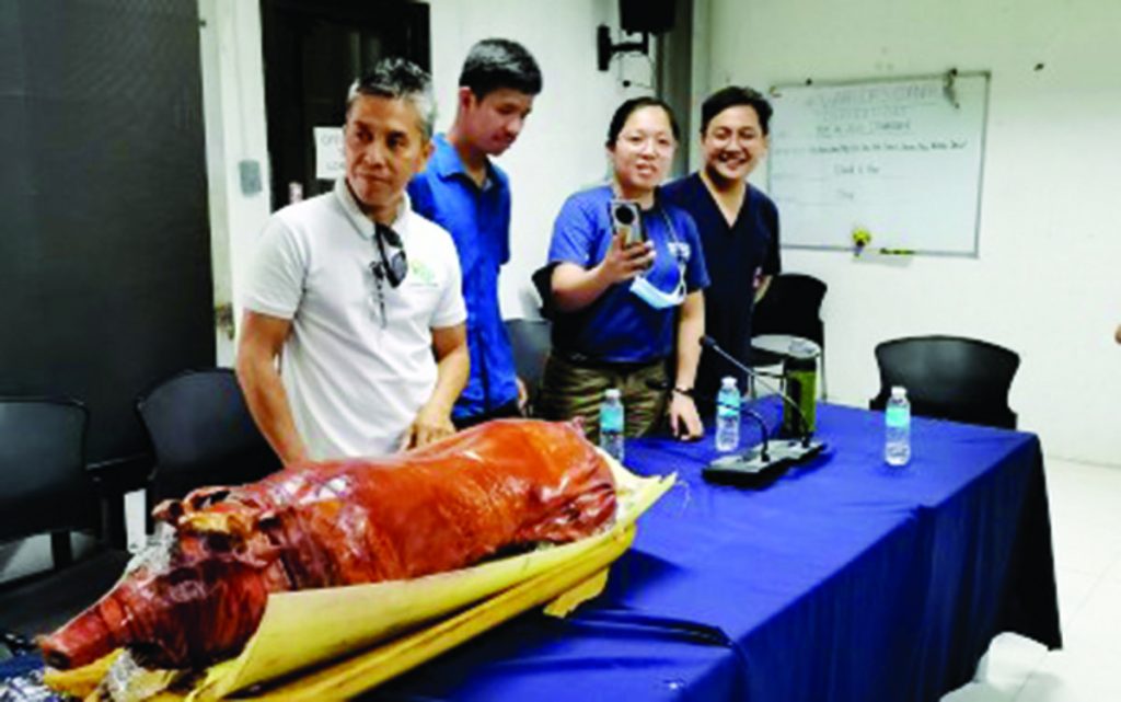 Officers of the Bureau of Animal Industry (BAI) in Negros Oriental await the signal to partake of lechon, during a press conference in Dumaguete City on Wednesday, May 31, 2023. The BAI central office has sent augmentation personnel to the province to help contain the spread of ASF that has affected some barangays in Dauin and Sibulan towns. (Judy Flores Partlow / PNA photo)