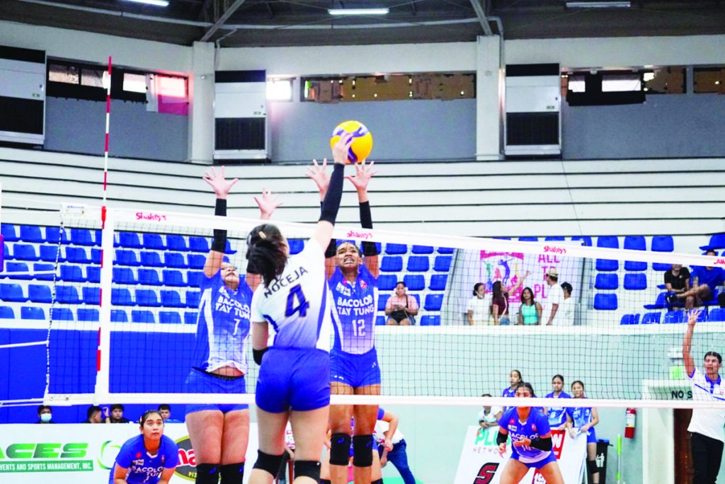 Bacolod Tay Tung High School Thunderbolts’ Dona Mae de Leon attempts to block the shot of Nazareth School of National University Lady Bullpups’ Yesha Noceja. (Photo courtesy of Shakey’s GVIL) 