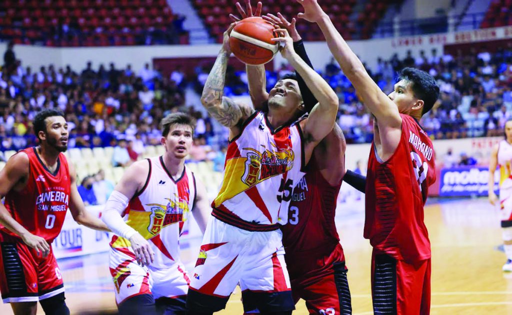 San Miguel Beermen’s Jeepy Faundo had his shot blocked by the defense of Barangay Ginebra San Miguel Kings’ Raymond Aguilar. (PBA photo)