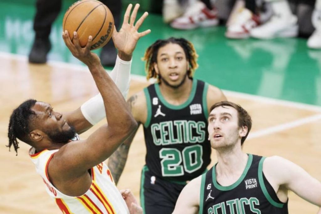 Atlanta Hawks forward Bruno Fernando (left) shoots over Boston Celtics center Luke Kornet in this file photo. (CJ Gunther / EPA-EFE / File photo)