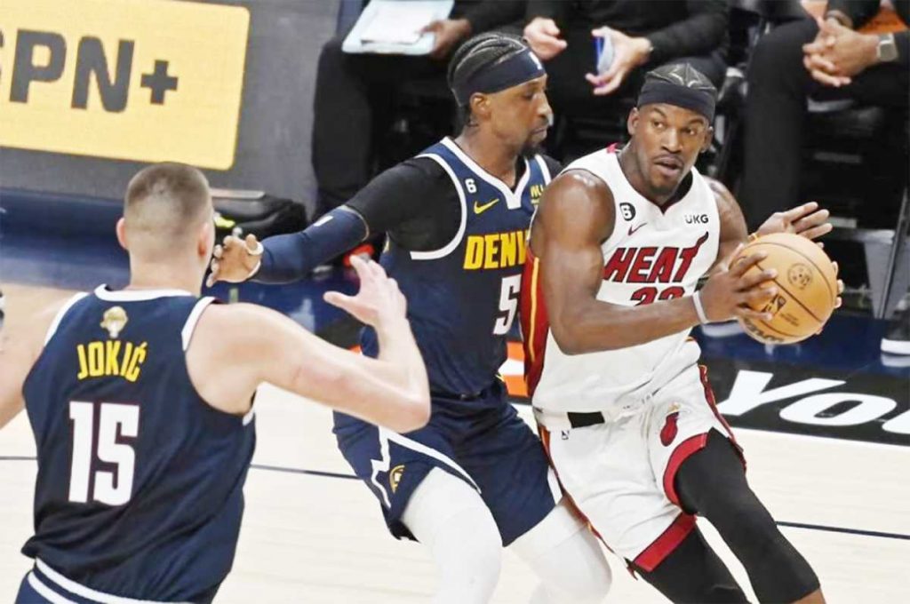 Miami Heat forward Jimmy Butler (right) drives to the basket while being guarded by Denver Nuggets forward Aaron Gordon during the second quarter of Game 2 of the NBA Finals at the Ball Arena in Denver, Colorado. (Bob Pearson / EPA-EFE photo)