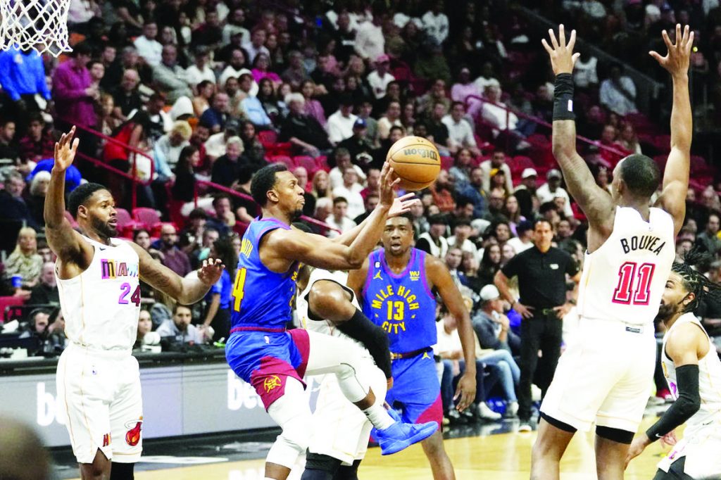 Denver Nuggets guard Ishmael Smith (14) passes the ball as Miami Heat forward Haywood Highsmith (24) and guard Jamaree Bouyea (1) defend during their NBA regular season match on February 13, 2023. A majority of coaches and sports personalities from Western Visayas see the Nuggets hoisting their first-ever NBA championship trophy at the expense of the Heat. (Lynne Sladky / AP photo)