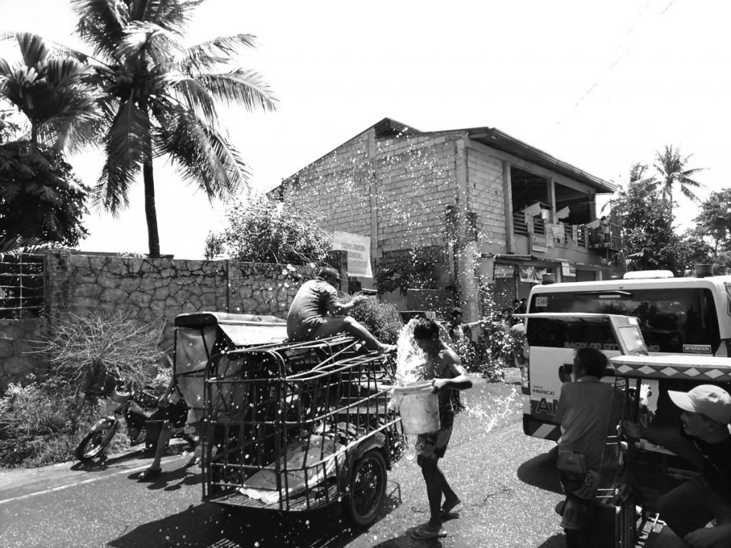 Residents throw water at motorists in Bacolod City’s Barangay Punta Taytay as the village celebrates the feast day of St. John the Baptist on Saturday, June 24, 2023. (Dominique Gabriel G. Bañaga photo)