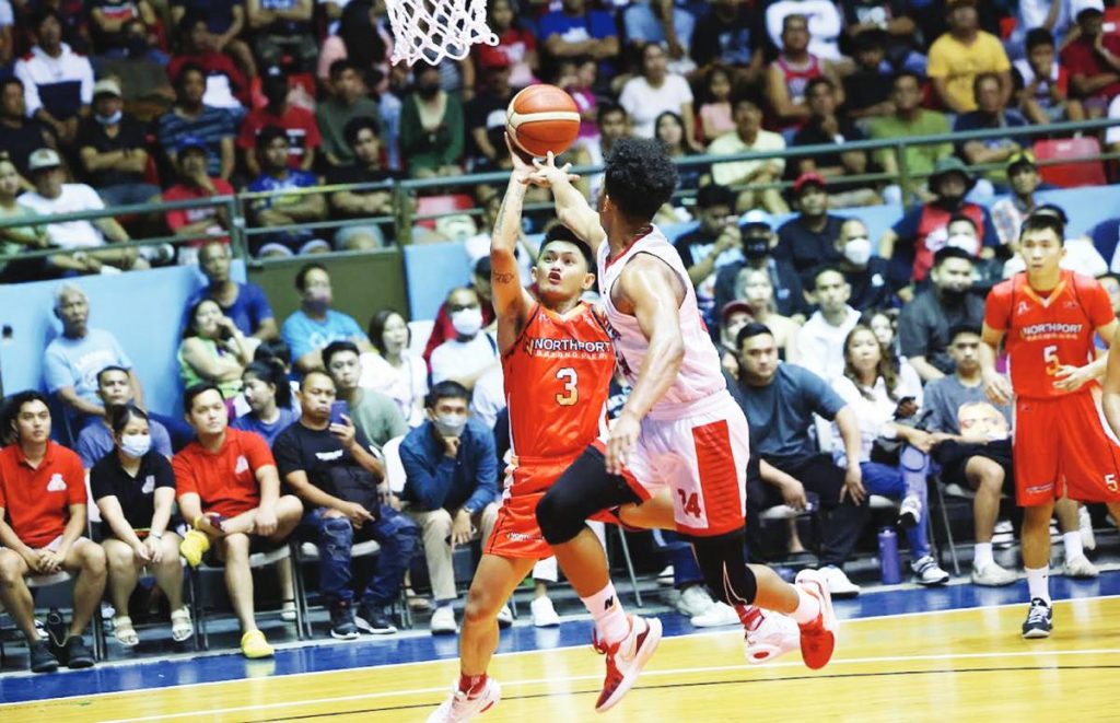 NorthPort Batang Pier’s Fran Yu goes for a tough shot against the defense of Barangay Ginebra San Miguel Kings’ Jayson David. (PBA photo)