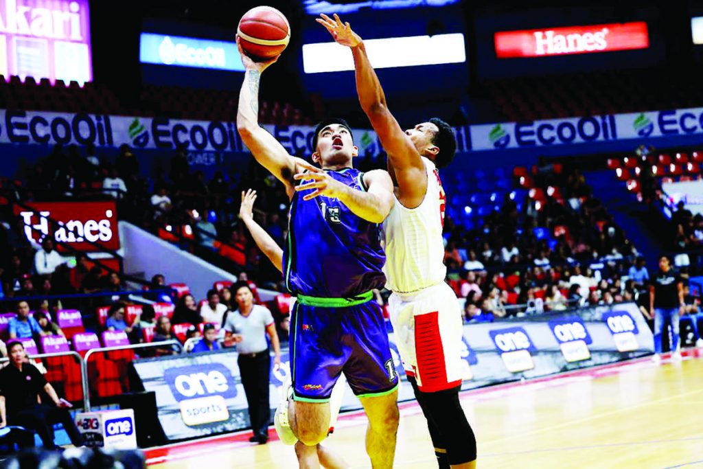 Converge FiberXers’ Justin Arana attacks the defense of Barangay Ginebra San Miguel Kings’ Sidney Onwubere for an inside shot. (PBA photo)