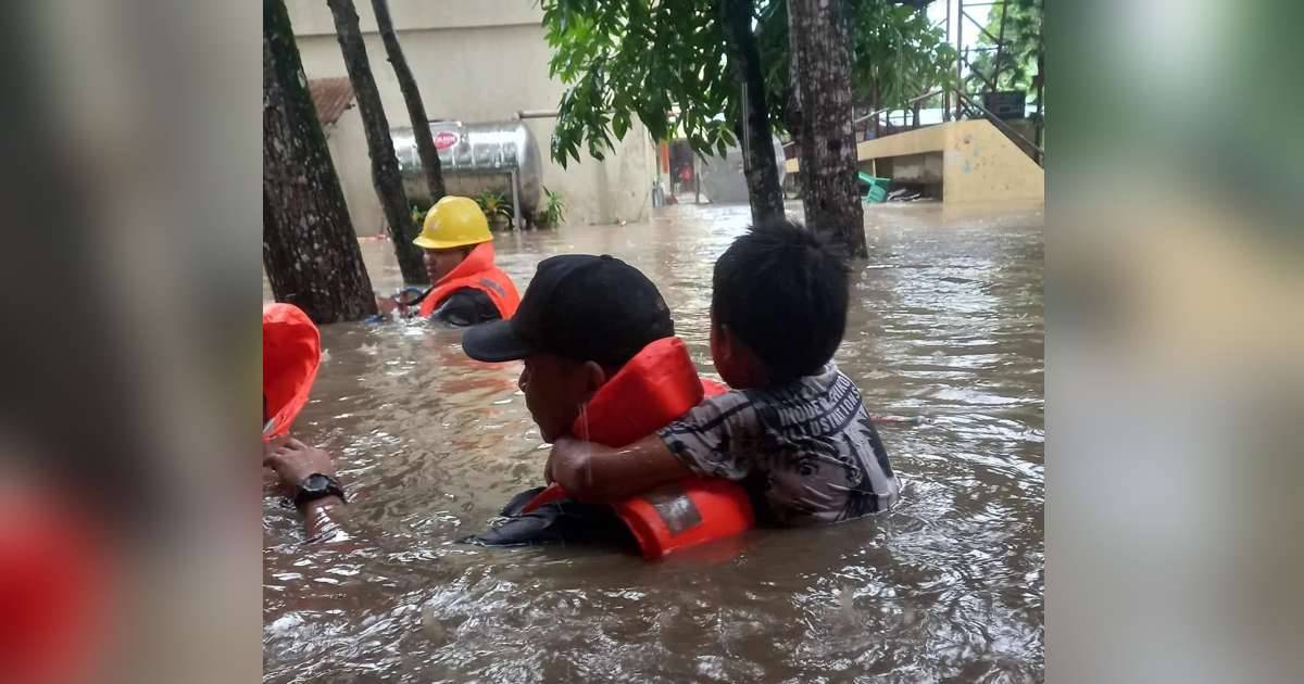 A boy was rescued by members of the Bureau of Fire Protection in Bacolod City and Amity Fire Brigade in chest-deep floodwaters in the city during the onslaught of the southwest monsoon enhanced by Typhoon "Goring" this week. (BFP Bacolod / Amity Fire Brigade photo)