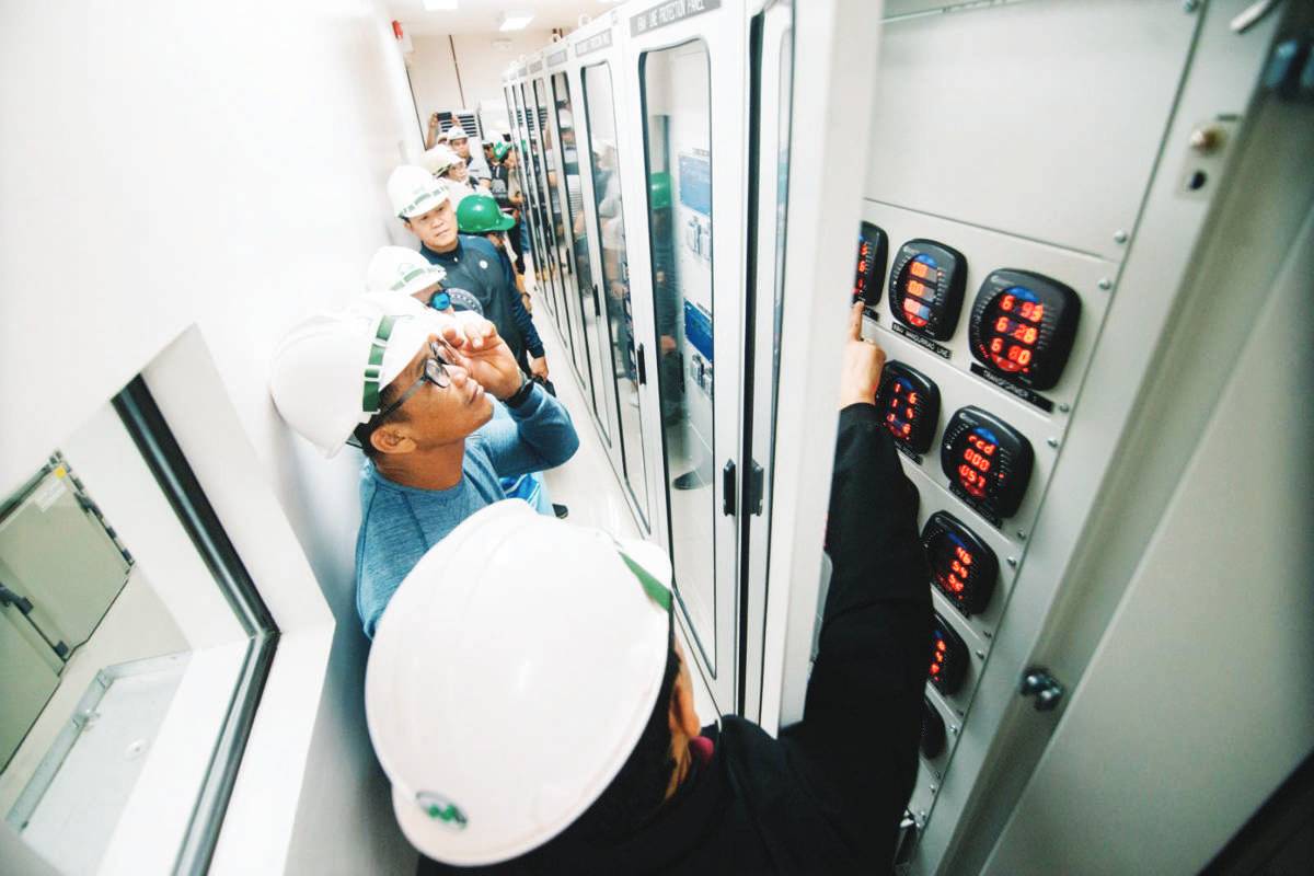 Employees of the Central Negros Electric Cooperative line up to check the modern power facilities and well-organized technology of MORE Electric and Power Corporation during a benchmarking initiative in Iloilo City. (MORE Power photo)