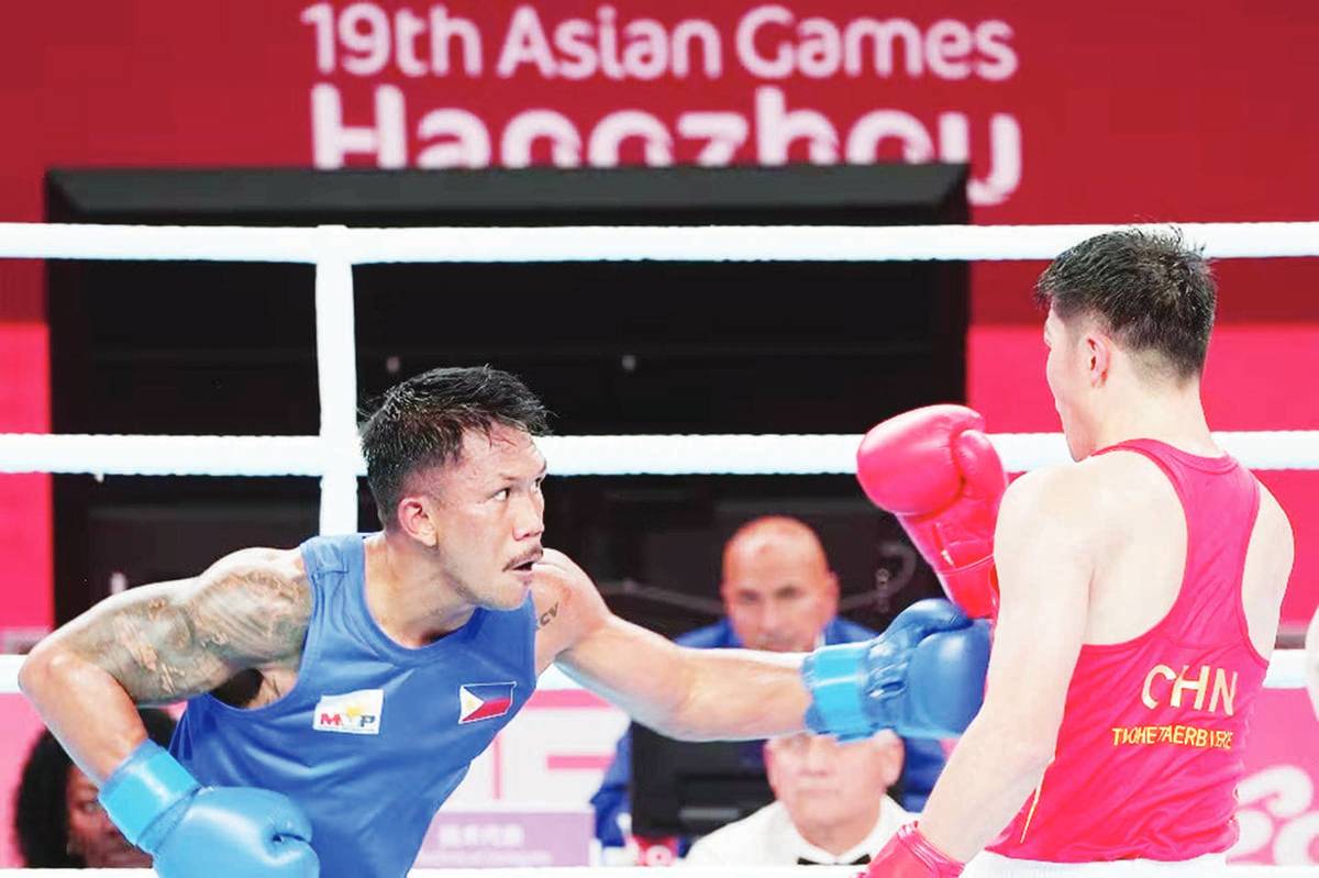 Eumir Marcial of the Philippines takes on Tuohetaerbieke Tanglatihan of China in their gold medal match of the men's 90-kilogram division during the Asian Games in Hangzhou, China on October 5, 2023. Marcial settled for silver after losing to his opponent on points. (PSC-POC Media pool / Handout)