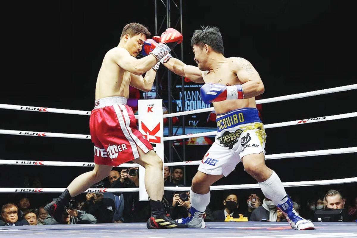 Manny Pacquiao (right) in action with South Korean mixed martial artist DK Yoo during their exhibition match in Goyang, Seoul on December 11, 2022. Pacquiao won the match with a unanimous decision. (EPA-EFE / YONHAP photo)