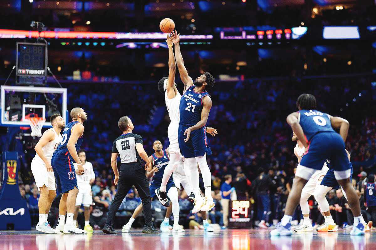 Philadelphia 76ers’ center Joel Embiid (21) and Cleveland Cavaliers’ center Jarrett Allen tip off to start the NBA game at the Wells Fargo Center. (Bill Streicher / Reuters photo)