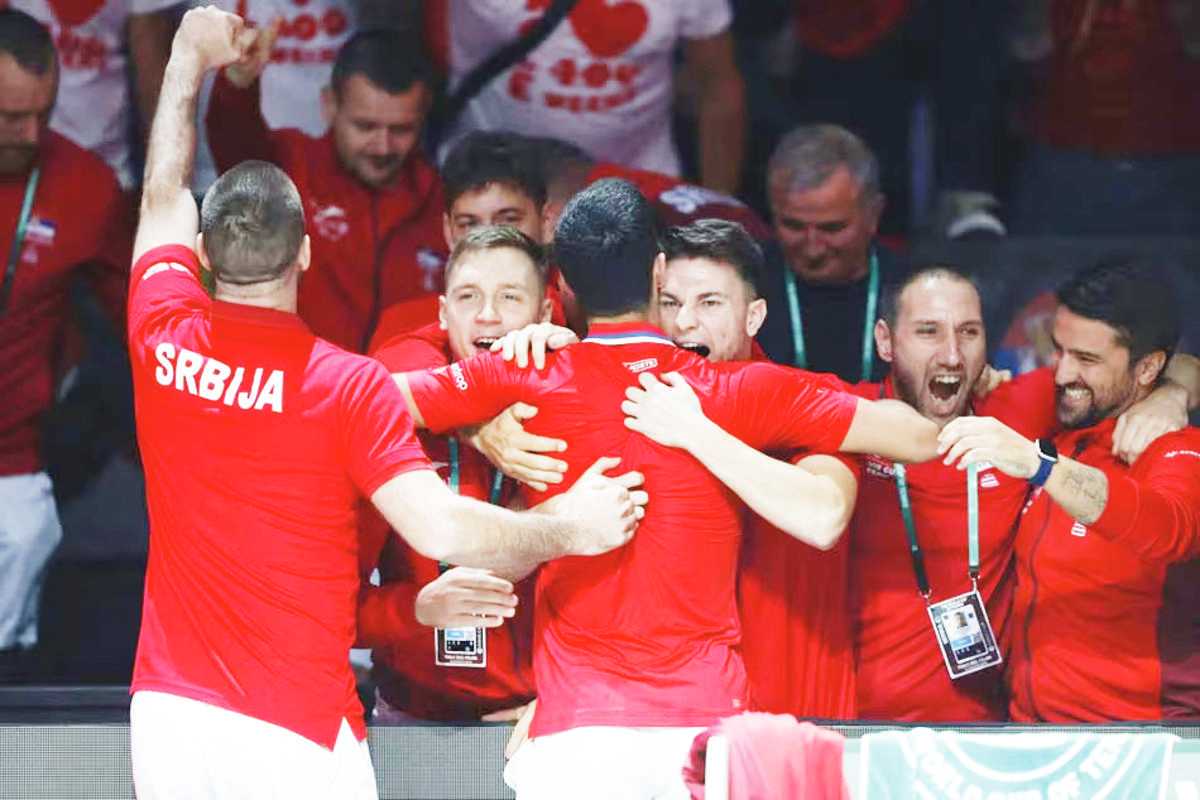 Novak Djokovic (second from left) of Serbia celebrates with teammates his victory over Cameron Norrie of Great Britain in a singles match of the Davis Cup quarterfinal tie between Serbia and Great Britain in Malaga, Spain. (Jorge Zapata / EPA-EFE photo)