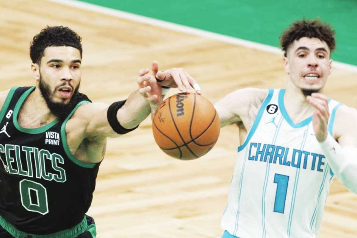 Boston Celtics forward Jayson Tatum (left) reaches for the loose ball with Charlotte Hornets guard LaMelo Ball during the second half of an NBA game in Massachusetts, USA. (CJ Gunther / EPA-EFE / File photo)  