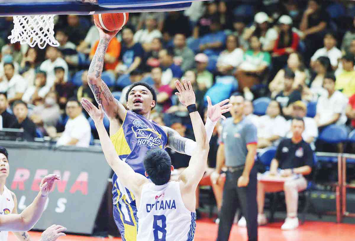 Magnolia Chicken Timplados Hotshots’ Tyler Bey shoots over the defense of TNT Tropang Giga’s Calvin Oftana. (PBA photo)