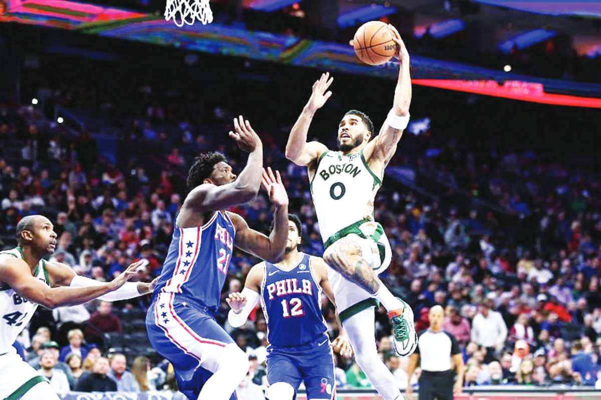 Jayson Tatum of the Boston Celtics drives for a lay-up past Joel Embiid of the Philadelphia 76ers at the Wells Fargo Centre on Wednesday, November 15, 2023. (AFP photo)