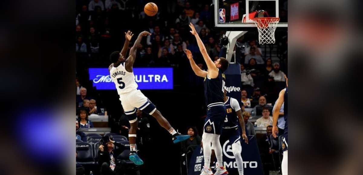 Anthony Edwards (5) of the Minnesota Timberwolves shoots the ball, while Nikola Jokic of the Denver Nuggets defends in the third quarter of their NBA game at the Target Center on Wednesday, November 1, 2023 in Minneapolis, Minnesota. (David Berding / Getty Images / AFP photo)