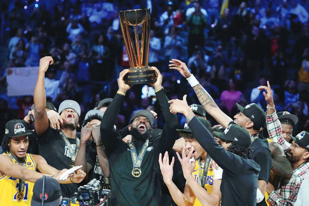 Los Angeles Lakers forward LeBron James celebrates with teammates after defeating the Indiana Pacers in the NBA in-season tournament championship at T-Mobile Arena. (Kyle Terada / Reuters photo)