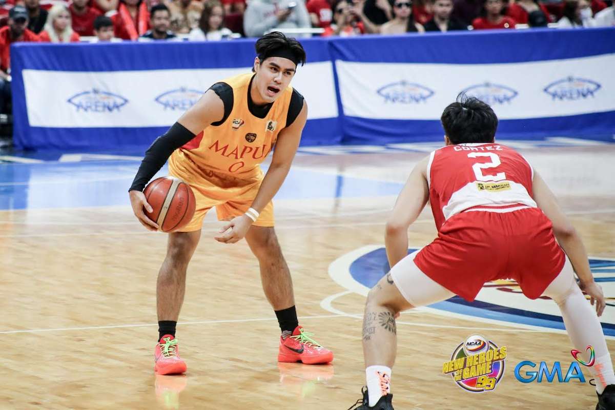 Mapua University Cardinals' Clint Escamis holds the ball while being defended by San Beda University Red Lions' Jacob Cortez. (NCAA / GMA Sports photo) 