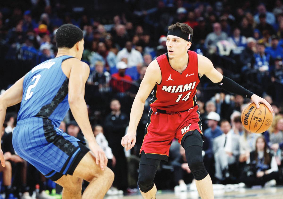 Miami Heat guard Tyler Herro drives to the basket as Orlando Magic guard Caleb Houstan defends during the second quarter of an NBA game at KIA Center. (Kim Klement Neitzel / Reuters photo)