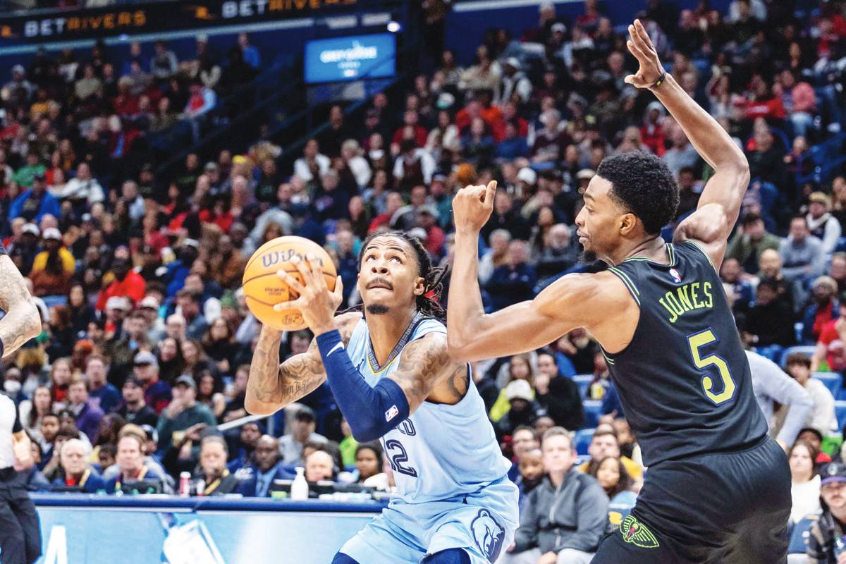 Memphis Grizzlies guard Ja Morant (12) drives to the basket against New Orleans Pelicans forward Herbert Jones during the second half of an NBA game at Smoothie King Center. (Stephen Lew photo)