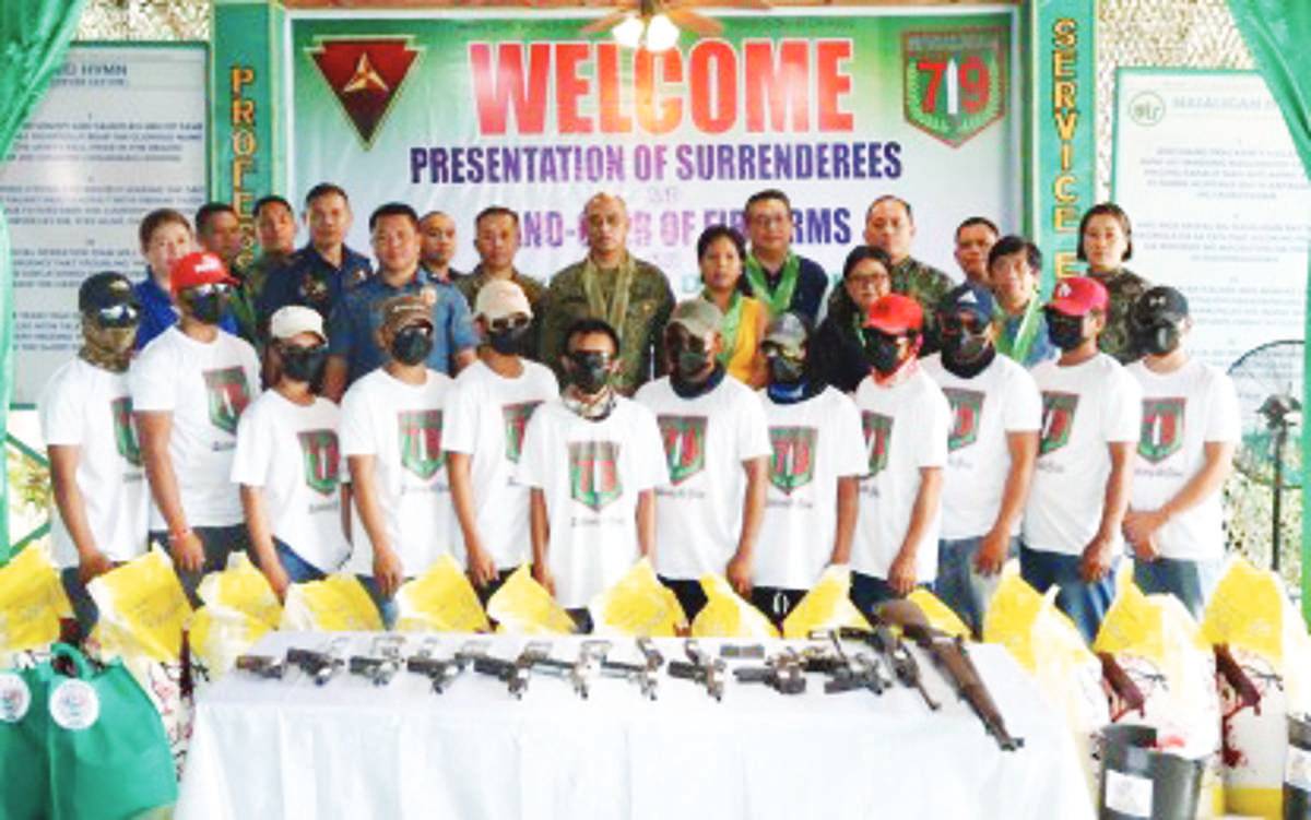 Communist Party of the Philippines-New People's Army (NPA) members pose with military officials in one of the ceremonies held for their surrender. Visayas Command commander, Lt. General Benedict Arevalo says the severe reduction in manpower and armed capability of the insurgents significantly contributed to the clearing of 343 NPA-infested communities in Visayas. (Viscom-PIO photo)