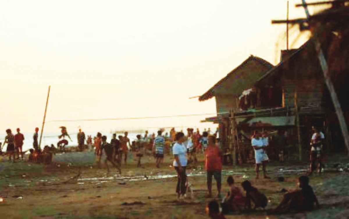 Residents of Iloilo City’s Barangay Calaparan stay along the coastline while waiting for power to be restored on January 5, 2024. (Iloilo City Mayor’s office photo)