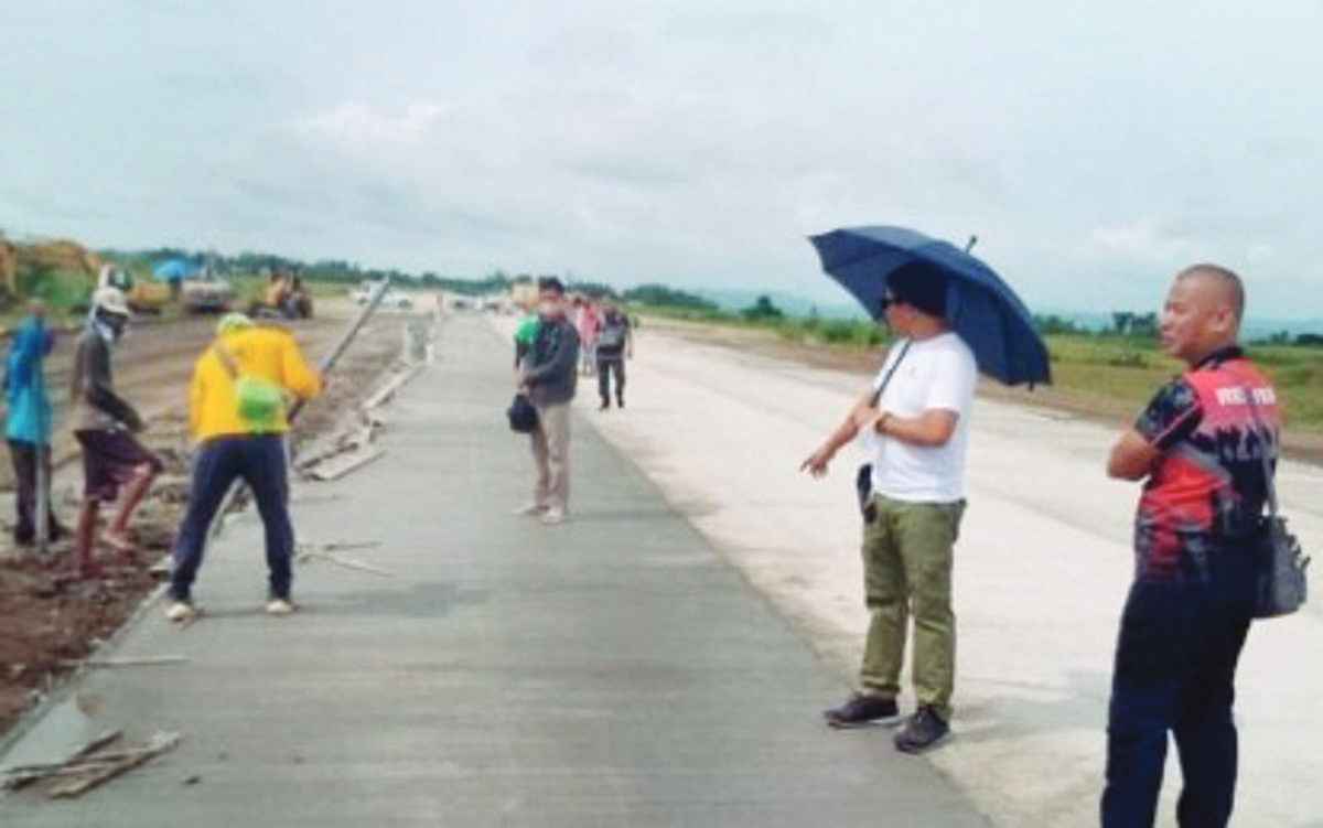 Kabankalan City Mayor Benjie Miranda inspects the construction of the Kabankalan City Domestic Airport’s runway in this file photo in 2022. Around 100 families living near the airport will be affected by the expansion of its runway to accommodate bigger aircraft. (PNA / File photo)  