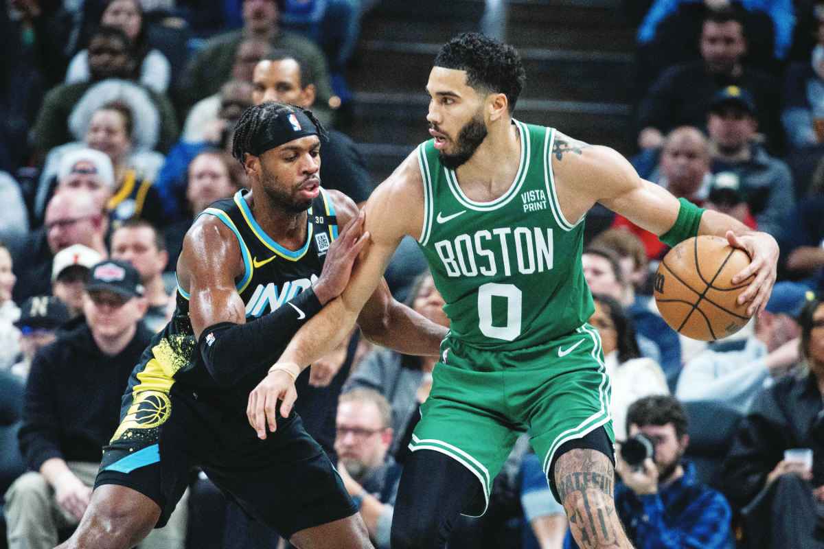 Boston Celtics forward Jayson Tatum (right) dribbles the ball against Indiana Pacers guard Buddy Hield. (Trevor Ruszkowski / Reuters photo)