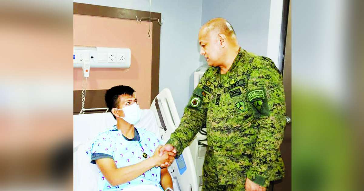 Colonel Victor Llapitan, deputy commander of the 303rd Infantry Brigade, awarded the Wounded Personnel Medal to one of the injured soldiers following a series of encounters in northern Negros on Friday, February 23, 2024. (303rd Infantry Brigade photo)